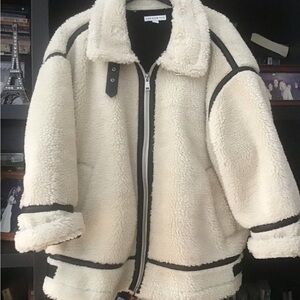 Cream Sherpa Jacket with Black faux leather Accents.  Beautiful design
